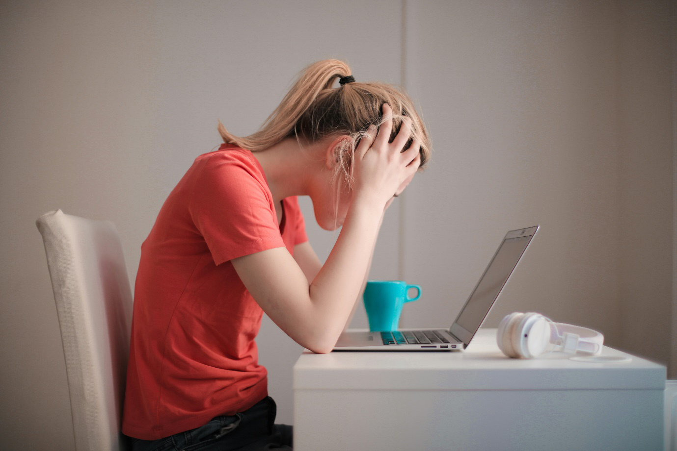 a woman looking at her laptop