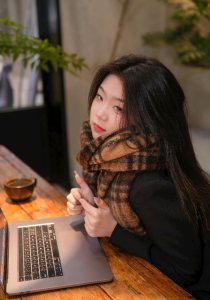 a woman sitting with laptop