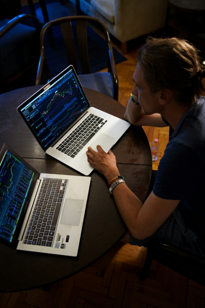 a person working on two laptops