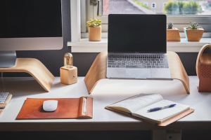 a laptop next to a PC.