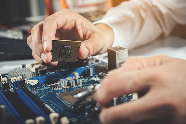 a person fixing computer hardware