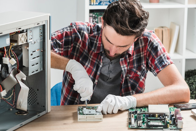 a person fixing a computer component