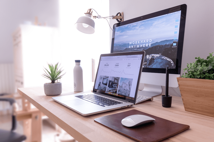 a laptop and a mouse on a desk