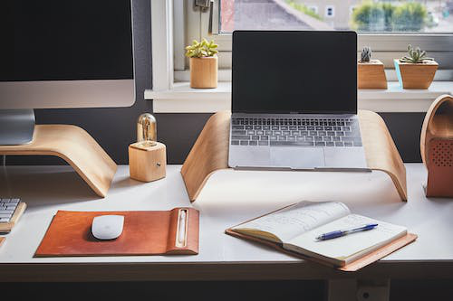 a laptop and computer on a desk