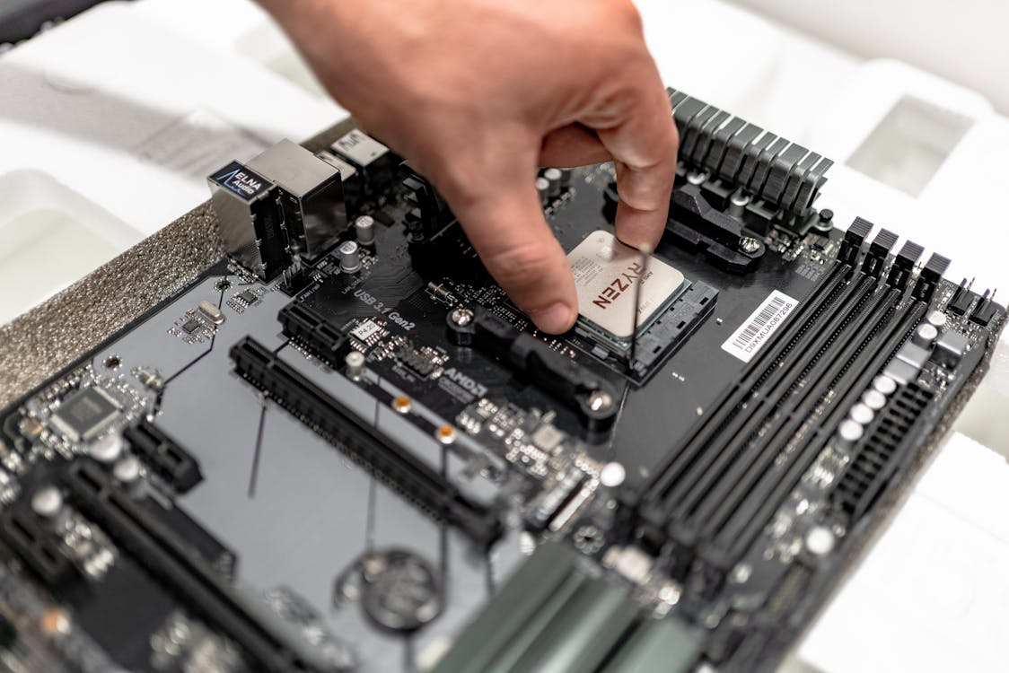 A PC repair technician installing a new computer processor in a PC