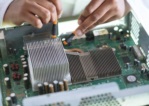 a person fixing a motherboard