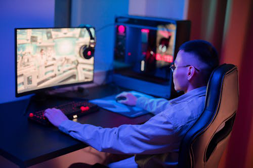 a person playing a game on a computer while sitting in a chair