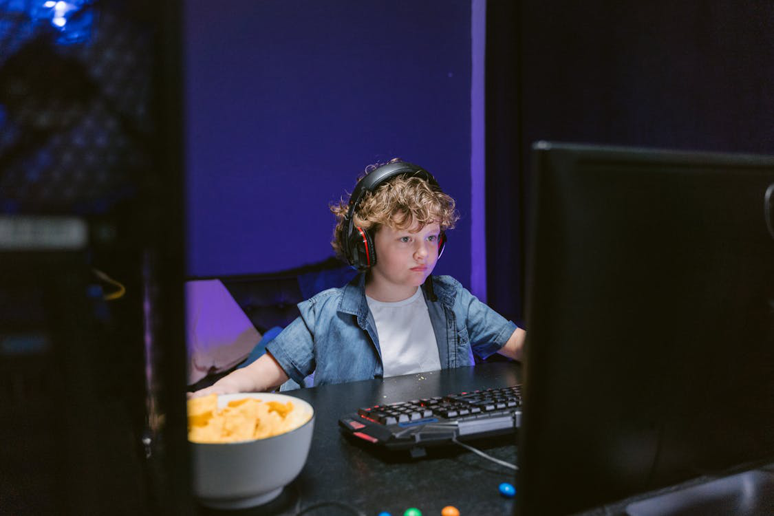 A kid playing on his gaming PC.