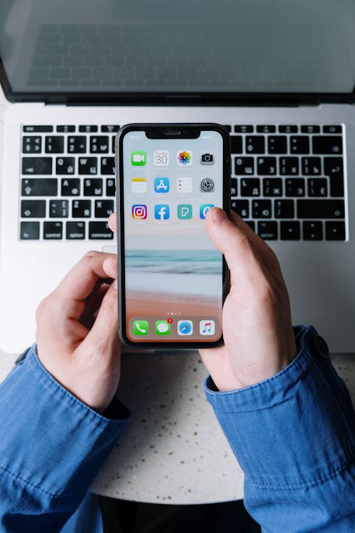 A person holding their broken screen.