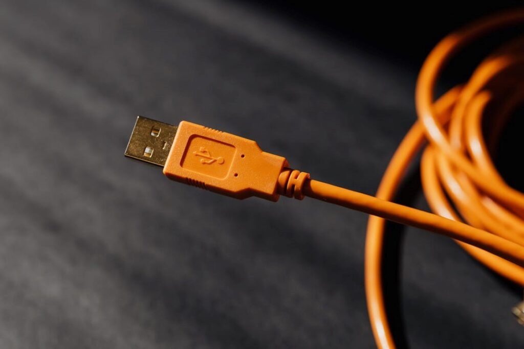 An orange USB cable for data transfer