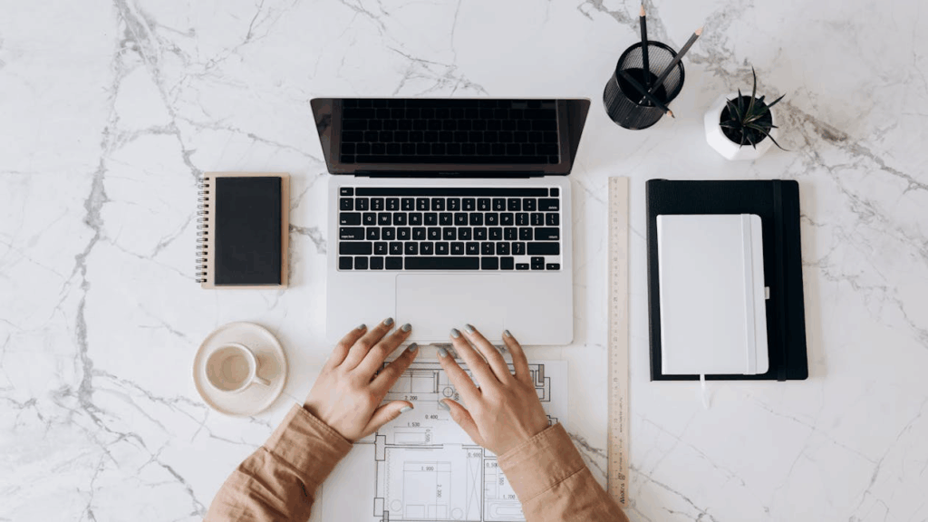 Cropped photo of a person working on a laptop