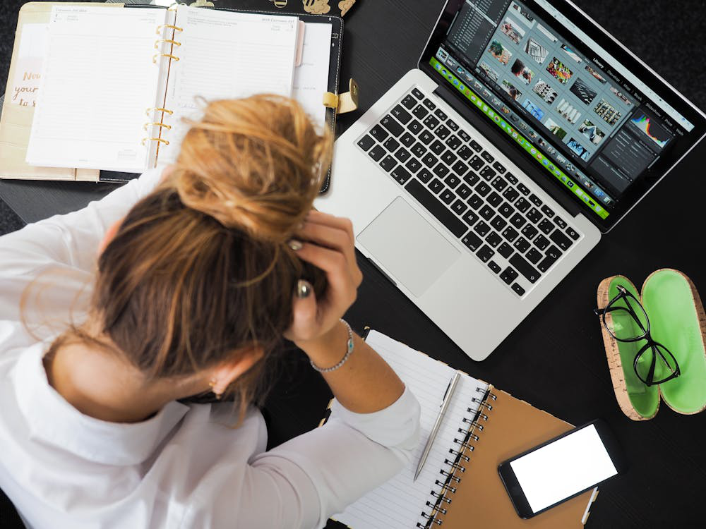 A woman feeling stressed due to a computer issue with connectivity
