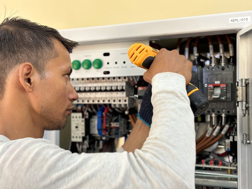 A man working on repairing a computer system.