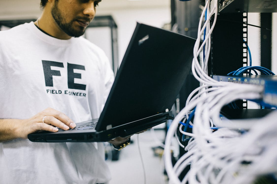 A technician repairing a laptop