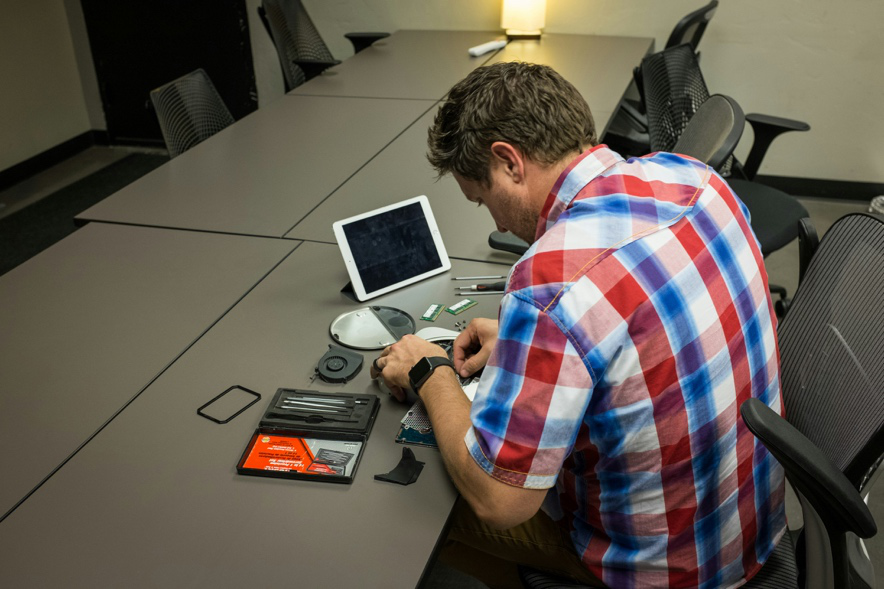 A technician performs remote diagnostics and software upgrades to improve computer performance without requiring in-person service.